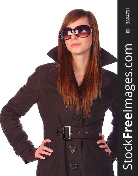 Teenage girl girl in trenchcoat, with sunglasses, with arms on hip, isolated on white. Teenage girl girl in trenchcoat, with sunglasses, with arms on hip, isolated on white
