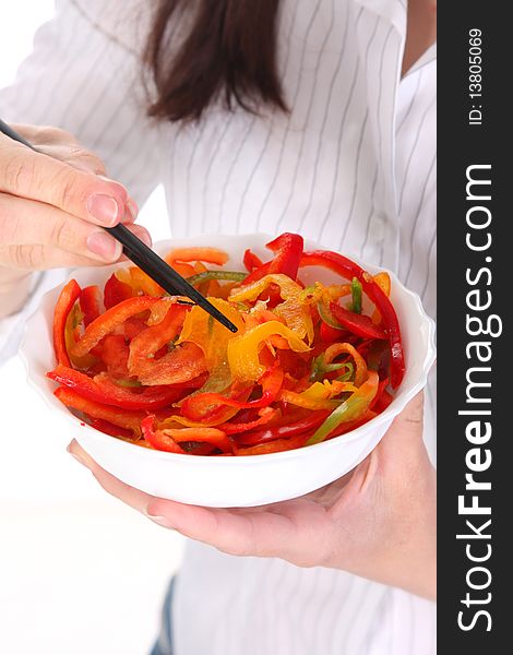 Chopsticks, bowl and peppers in close up