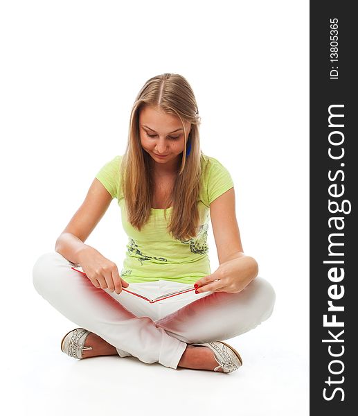 The young beautiful student with the book isolated on a white background