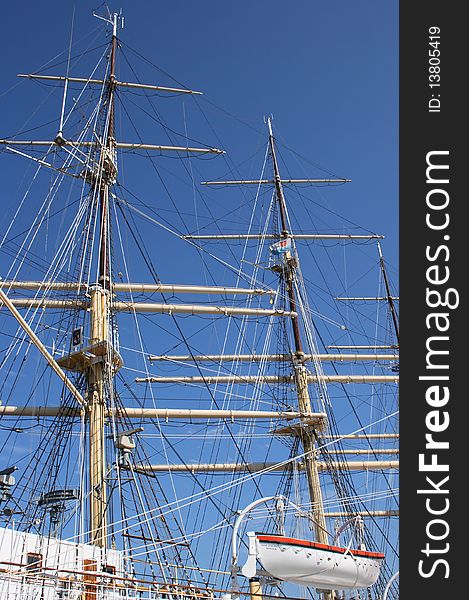 Two masts and lifeboat on white sailing boat