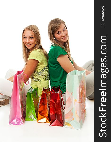 Two beautiful girls with packages isolated on a white background