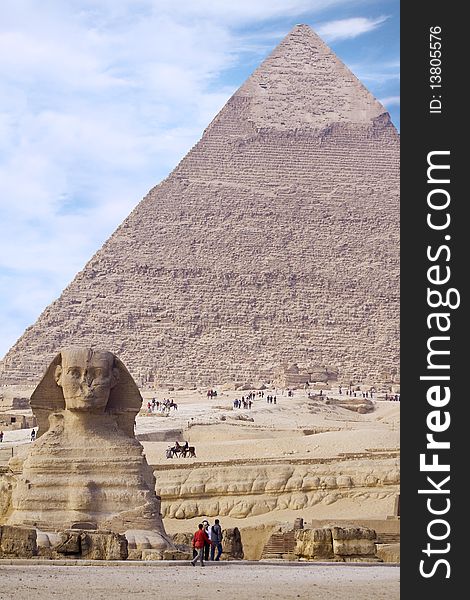 Ancient Egyptian Sphinx with old historic pyramid behind. Ancient Egyptian Sphinx with old historic pyramid behind