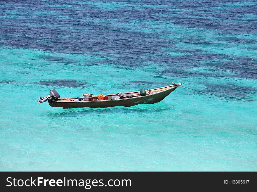 Lonely boat in turquoise sea waters