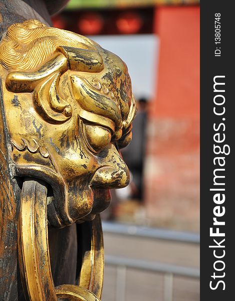 Gold Lion figure on Urn in Forbidden City. Gold Lion figure on Urn in Forbidden City