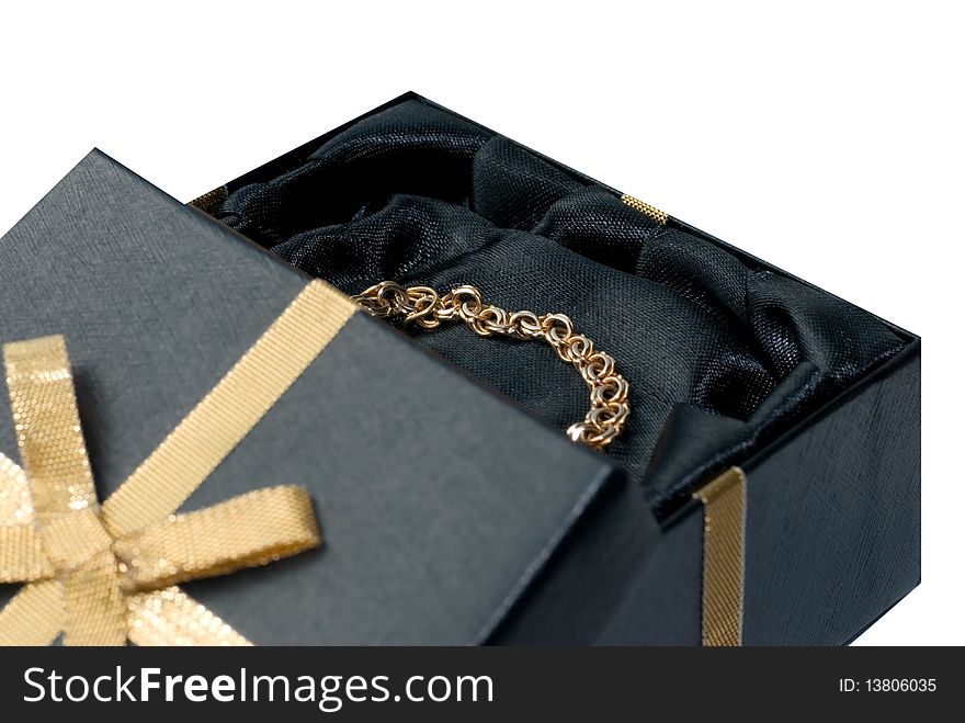 Gold chain in a black box with gold ribbon. Gold chain in a black box with gold ribbon.