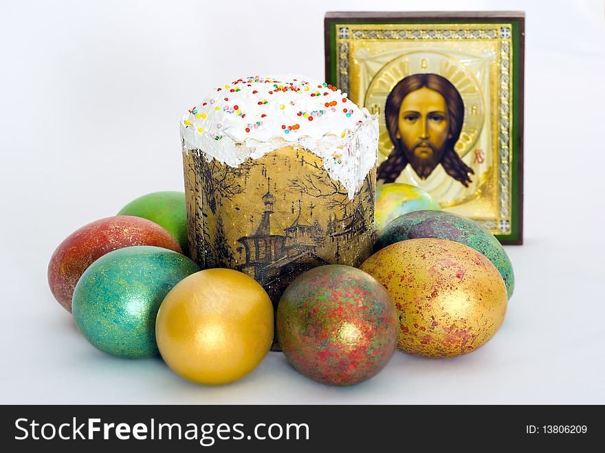 Easter eggs and Easter cake against an icon