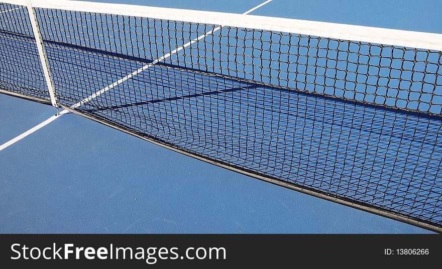 Closeup of the net at the outdoor tennis court.