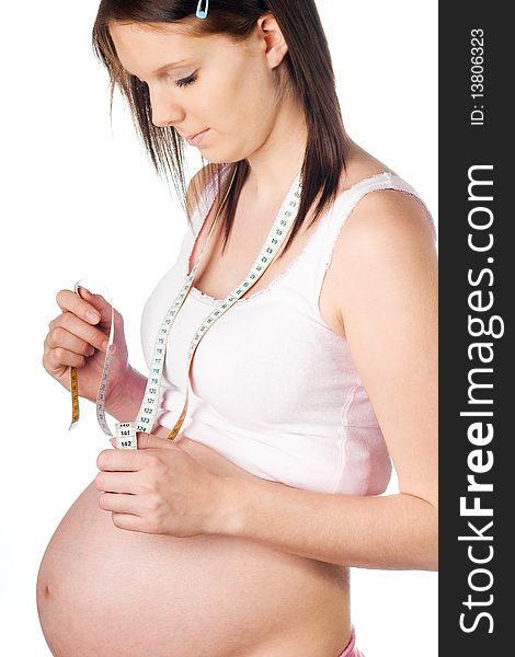 Pregnant girl with measuring tape around her neck