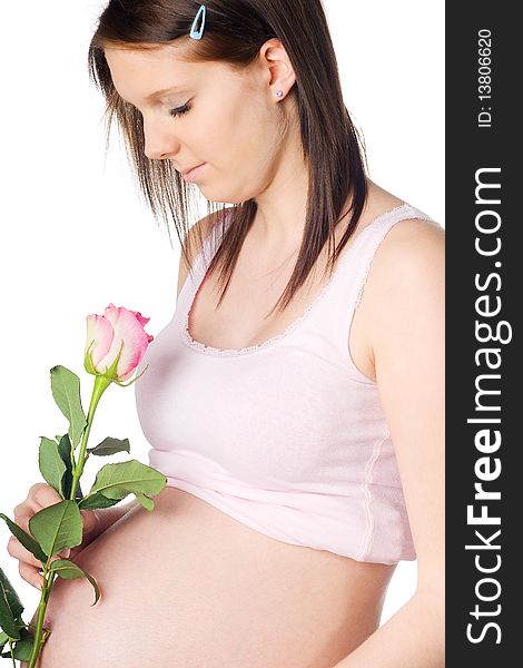 Pregnant girl with rose in the hand isolated on white background