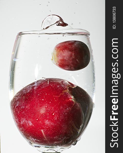 Splash of water with grape fruit and cherry