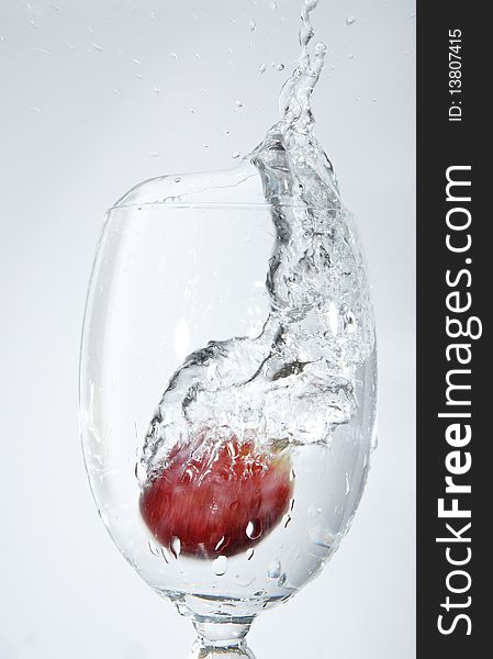 Macro shot of isolated splash of water in a cup on white background. Macro shot of isolated splash of water in a cup on white background