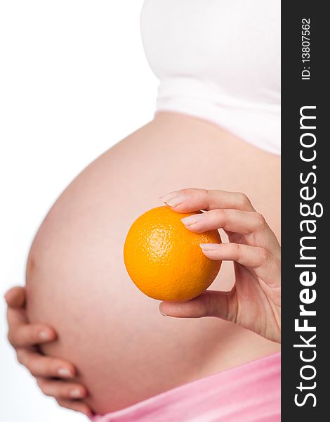 Pregnant girl with an healthy orange in the hand. Pregnant girl with an healthy orange in the hand