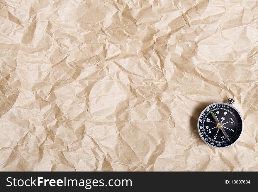 Background with brown paper  and compass. Background with brown paper  and compass