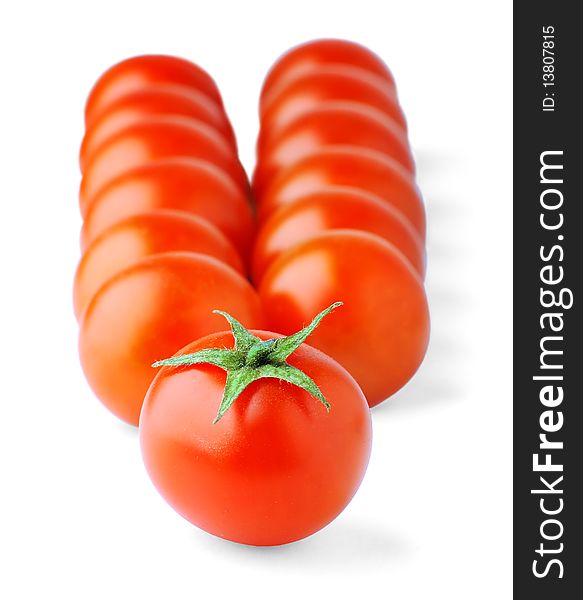 Cherry tomatoes in a row over white background