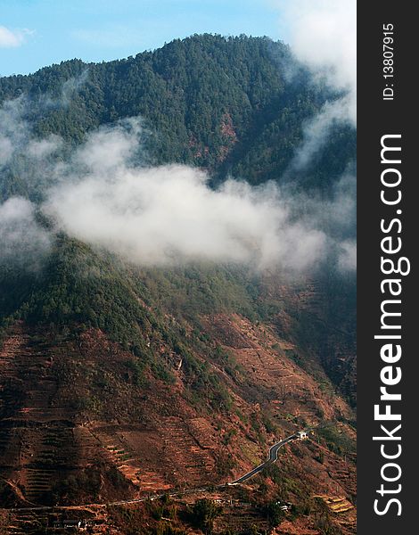 A view of mountain in Yunnan, China. Surround with clouds.