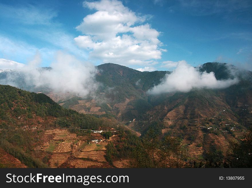 A view of mountain in Yunnan, China. Surround with clouds.