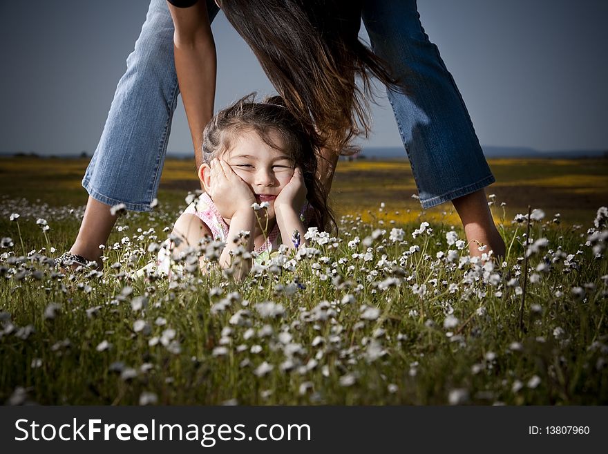 Little girl being lifted up by her mom. Little girl being lifted up by her mom