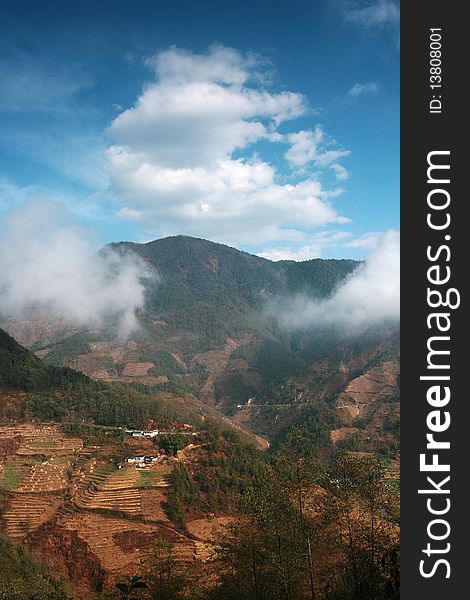 A view of mountain in Yunnan, China. Surround with clouds.