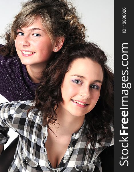 Portrait of the young beautiful girls with radiant eyes in a checkered shirt
