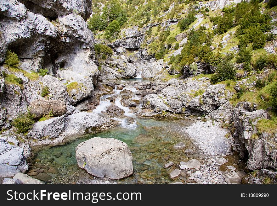 View on River Bellos in big Canyon Anisclo in Ordesa Nation Park in Pyrenees, Spain. Autumn time. View on River Bellos in big Canyon Anisclo in Ordesa Nation Park in Pyrenees, Spain. Autumn time.