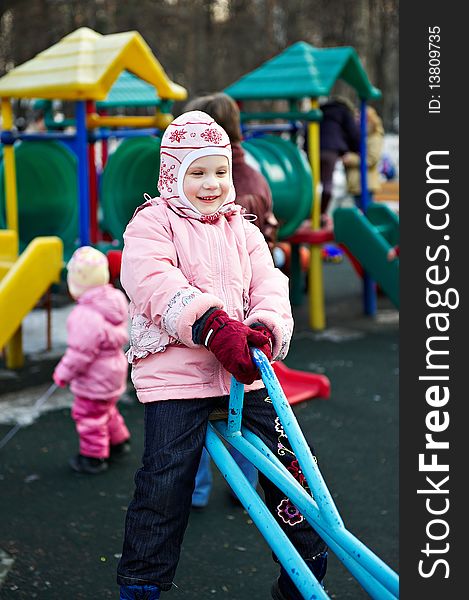 Little girl on a walk in swing