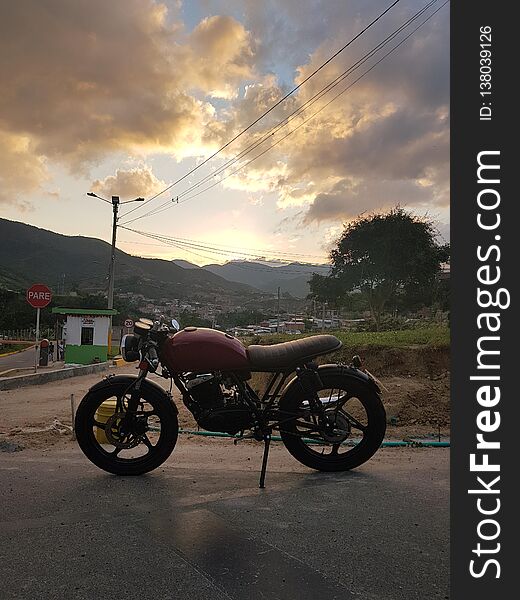 Sunset over mountains, and the motorcycle ready to fo far away and beyond. Sunset over mountains, and the motorcycle ready to fo far away and beyond.