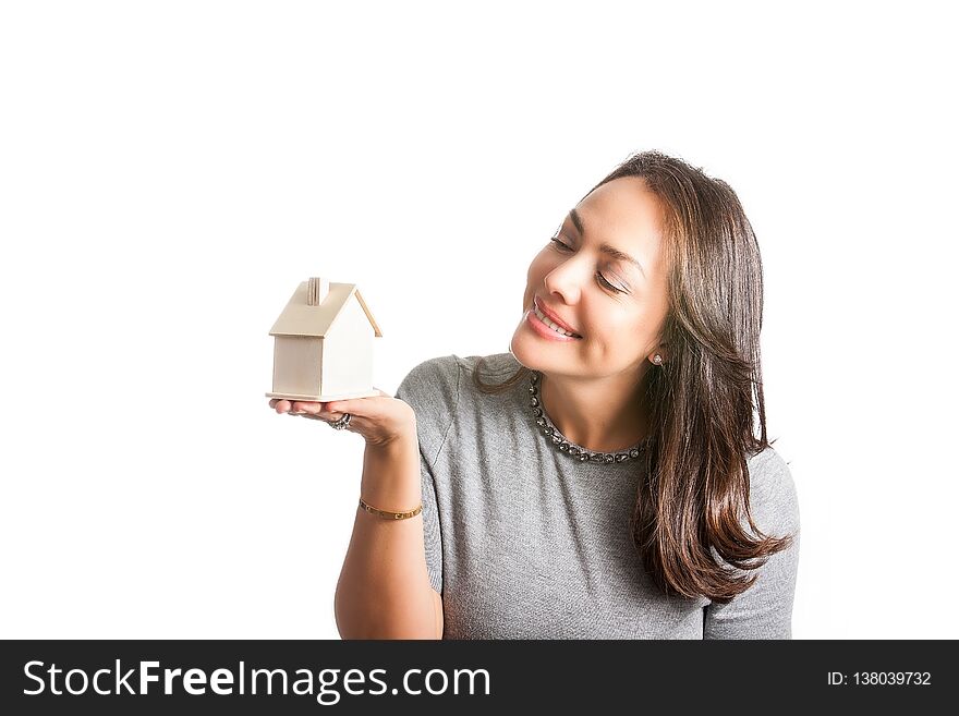 Young beautiful woman dreaming with a new house isolated