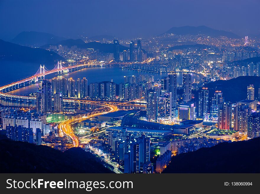 Busan cityscape with skyscrapers and Gwangan Bridge illuminated at night. Busan. South Korea. Busan cityscape with skyscrapers and Gwangan Bridge illuminated at night. Busan. South Korea