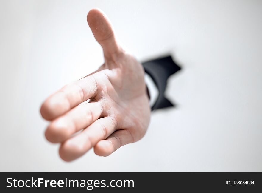 Close up. businessman holding out his hand for a handshake.photo with copy space