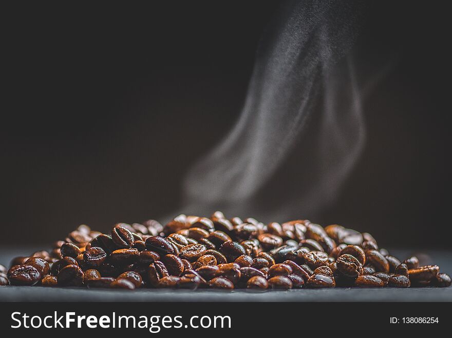 Hot coffee beans and smoke, macro photography