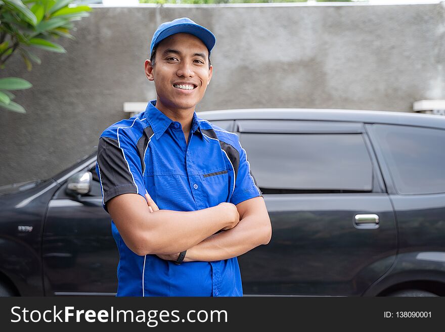 Portrait of asian car mechanic smiling to camera. home service concept