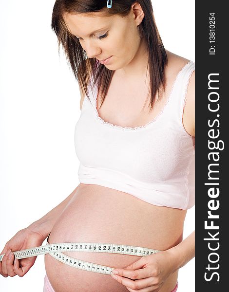 Pregnant girl with measuring tape around her belly. Pregnant girl with measuring tape around her belly