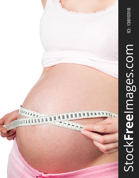 Pregnant girl with measuring tape around her belly. Pregnant girl with measuring tape around her belly