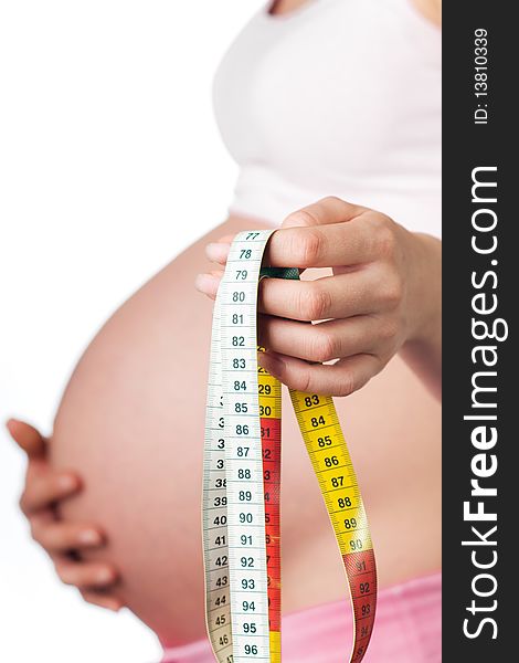 Pregnant girl with measuring tape in the hand