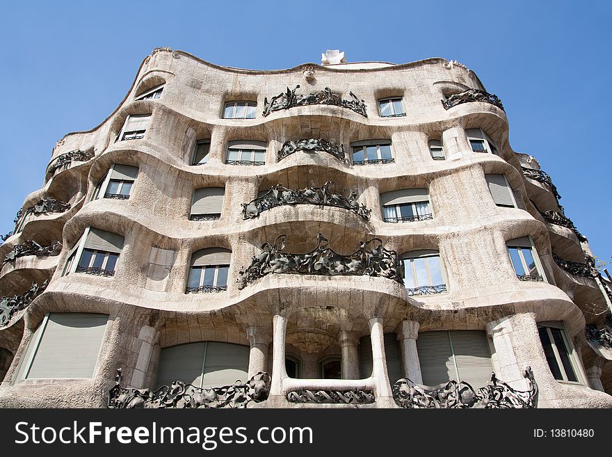Facade of Casa Mila, also known as La Pedrera, designed by Antoni Gaudi and completed in 1912. The building is located at 92, Passeig de Gracia street in the Eixample -or ensanche- district of Barcelona (Spain). Facade of Casa Mila, also known as La Pedrera, designed by Antoni Gaudi and completed in 1912. The building is located at 92, Passeig de Gracia street in the Eixample -or ensanche- district of Barcelona (Spain).