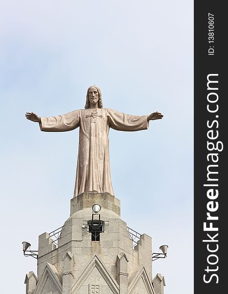 A huge bronze statue of Jesus Christ located on the top of Sagrat Cor temple (Tibidabo mountain, Barcelona). A huge bronze statue of Jesus Christ located on the top of Sagrat Cor temple (Tibidabo mountain, Barcelona).