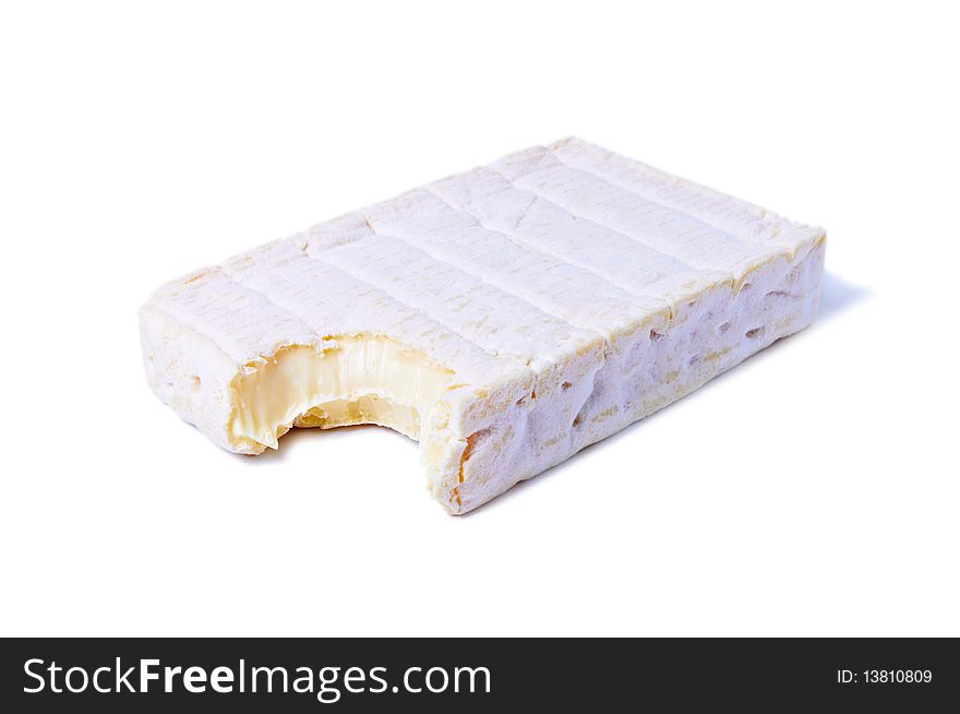 Bitten piece of Gourmet Brie Cheese isolated on white