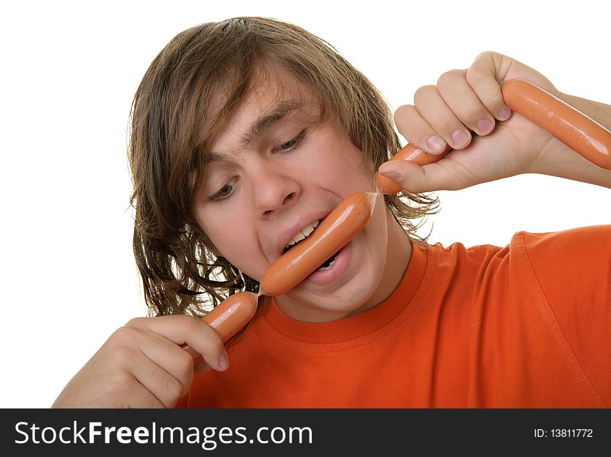 Teenager with appetite bites sausages isolated in white