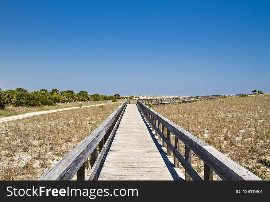 Wooden boardwalk in the dunes. Smyrna Dunes Beach Park, Florida