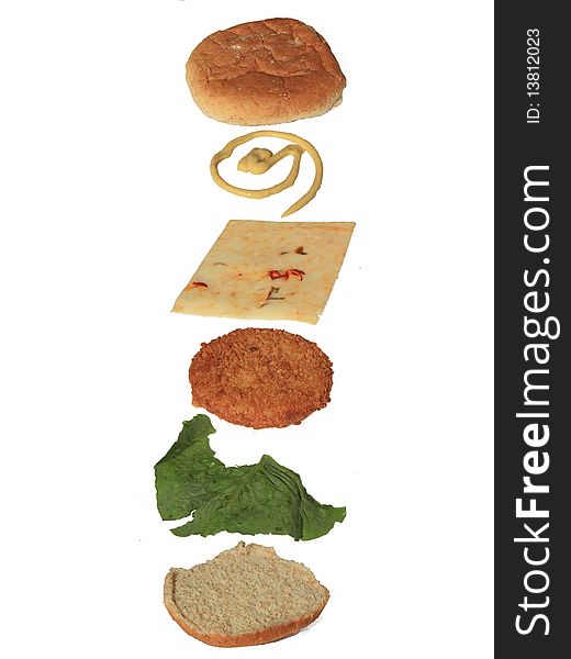 An exploded view of a vegetarian chicken patty sandwich. An exploded view of a vegetarian chicken patty sandwich