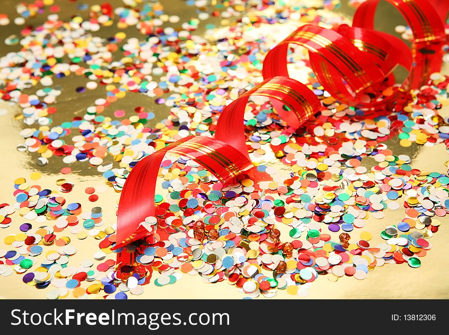 Streamer and color confetti on a gold background. Streamer and color confetti on a gold background