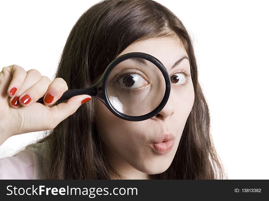 Pretty young woman looking through magnifying