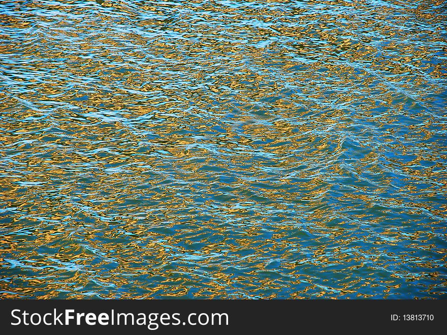 Natural river water surface in blue and gold