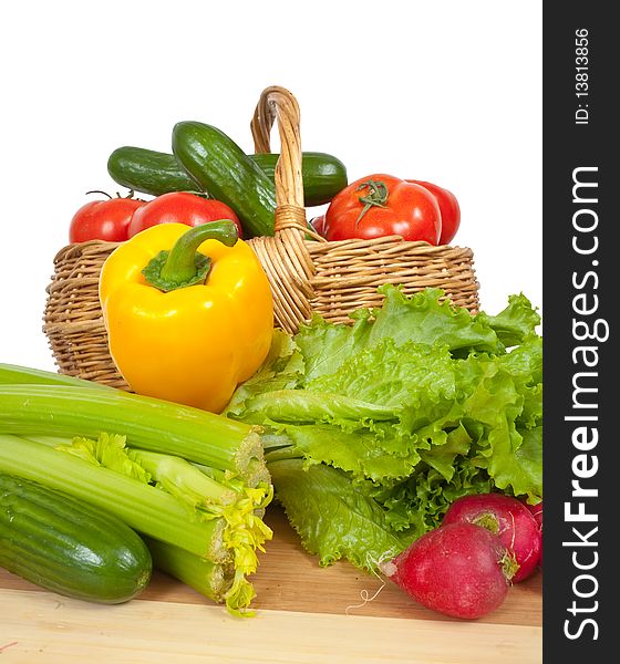 Ripe vegetables in basket on white background