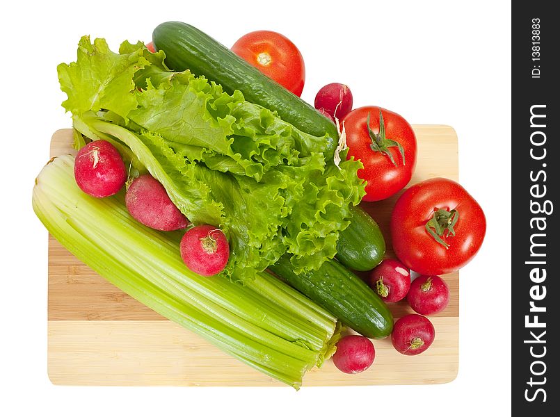 Vegetables on wooden cutting board  over white background