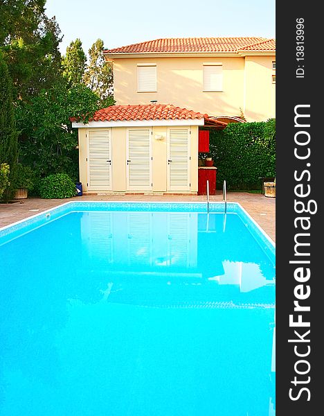 House and swimming pool, vertical picture.