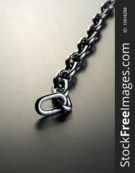 Steel chain on a metal background. Steel chain on a metal background