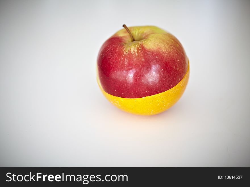 Orange and apple fruit cut in halves and as one fruit. Orange and apple fruit cut in halves and as one fruit.