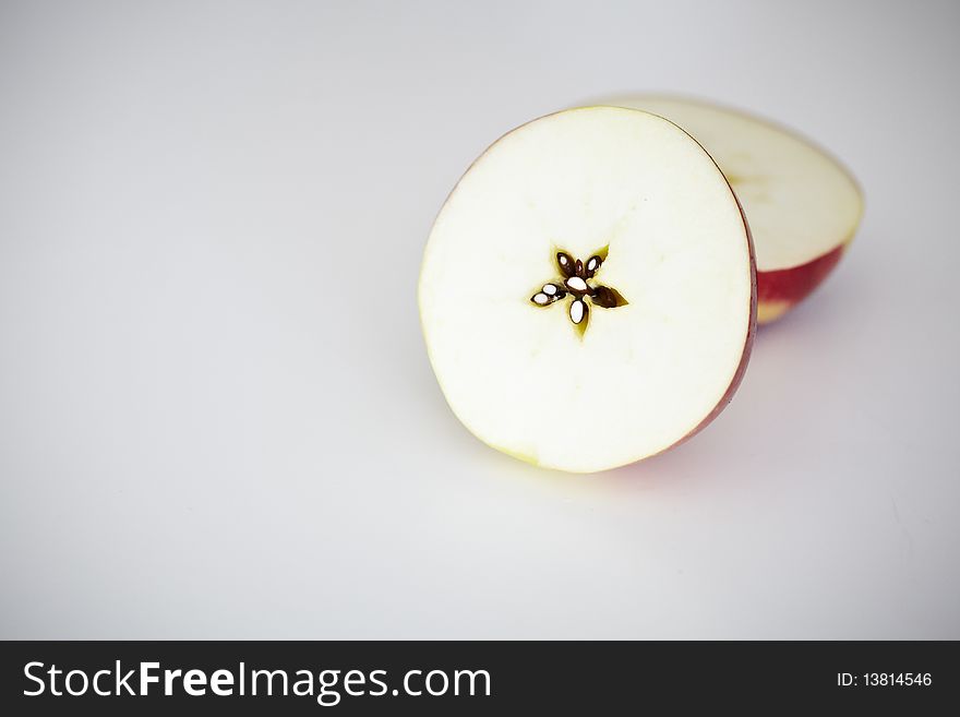 Apple sliced in two halves showing a center star. Apple sliced in two halves showing a center star.