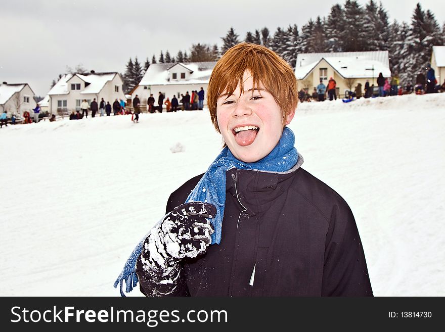 Boy with red hair enjoying   the snow